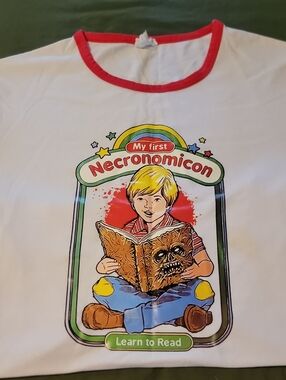 White T-Shirt with Red Trim and 'My First Necronomicon' Graphic